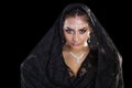 Portrait of a beautiful woman with arabian makeup in black paranja