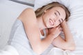 Portrait of beautiful woman awakening in her white bed and yawning.Rest,sleeping,people and comfort concept. Royalty Free Stock Photo