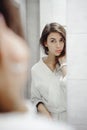 Portrait of a beautiful woman in bathroom. cheerful young girl washes, brushes her teeth with a toothbrush Royalty Free Stock Photo