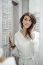 Portrait of a beautiful woman in bathroom. cheerful young girl washes, brushes her teeth with a toothbrush Royalty Free Stock Photo