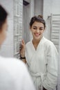Portrait of a beautiful woman in bathroom. cheerful young girl washes, brushes her teeth with a toothbrush Royalty Free Stock Photo