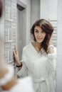 Portrait of a beautiful woman in bathroom. cheerful young girl washes, brushes her teeth with a toothbrush Royalty Free Stock Photo