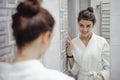 Portrait of a beautiful woman in bathroom. cheerful young girl washes, brushes her teeth with a toothbrush Royalty Free Stock Photo