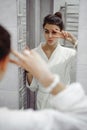 Portrait of a beautiful woman in bathroom. cheerful young girl washes, brushes her teeth with a toothbrush Royalty Free Stock Photo