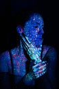 Portrait of a beautiful woman with blue sequins on her face. Girl with artistic make-up in Light color. Fashion model Royalty Free Stock Photo
