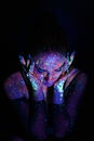 Portrait of a beautiful woman with blue sequins on her face. Girl with artistic make-up in Light color. Fashion model Royalty Free Stock Photo