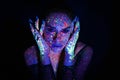 Portrait of a beautiful woman with blue sequins on her face. Girl with artistic make-up in Light color. Fashion model Royalty Free Stock Photo