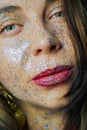 Portrait of a beautiful woman with blue sparkles on her face. Girl with colorful artistic make-up with glitter. Fashion Royalty Free Stock Photo