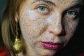 Portrait of a beautiful woman with blue sparkles on her face. Girl with colorful artistic make-up with glitter. Fashion Royalty Free Stock Photo