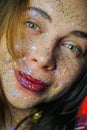 Portrait of a beautiful woman with blue sparkles on her face. Girl with colorful artistic make-up with glitter. Fashion Royalty Free Stock Photo