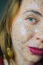 Portrait of a beautiful woman with blue sparkles on her face. Girl with colorful artistic make-up with glitter. Fashion Royalty Free Stock Photo