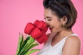 Beautiful woman with bouquet of red tulip flowers Royalty Free Stock Photo