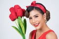 Portrait of Beautiful woman with bouquet of red tulip flowers Royalty Free Stock Photo