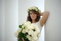 Portrait of a beautiful woman with a bouquet of white roses Royalty Free Stock Photo