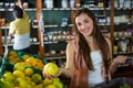 Portrait of beautiful woman buying sweet lime in organic section