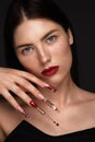 Portrait of a beautiful woman with classic make up in glamorous style, creative long nails. Design manicure. Beauty face