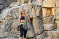 Portrait of Beautiful Woman Climber Holding the Rope near the Rock in the Mountains. Adventure and Extreme Sport Concept