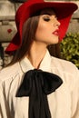 Portrait of beautiful woman with dark hair in elegant red hat Royalty Free Stock Photo