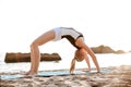 Portrait of a beautiful woman doing stretching exercises outdoors Royalty Free Stock Photo