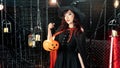 Portrait beautiful woman dressed as witch for Halloween holding lantern pumkin in holloween theme Royalty Free Stock Photo