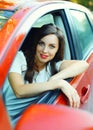 Portrait beautiful woman driver behind wheel red car Royalty Free Stock Photo