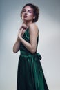 Portrait of beautiful woman in fashion green dress