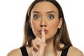 Portrait of a beautiful woman with a finger in front of her lips Royalty Free Stock Photo