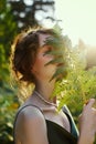 Portrait  beautiful woman in forest at sunset. Woman is resting in nature, an art portrait in the rays of the sun Royalty Free Stock Photo
