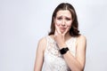 Portrait of beautiful woman with freckles and white dress and smart watch with tooth pain on silver gray background. Royalty Free Stock Photo