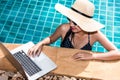 Portrait Beautiful Woman freelancer working on laptop computer in pool