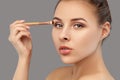 Portrait of a beautiful woman with fresh nude make-up, thick eyebrows and with clean skin. She does eye makeup. Cosmetology and Royalty Free Stock Photo