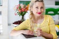 Portrait of a beautiful woman with a glass of water in the kitchen Royalty Free Stock Photo