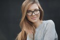 Portrait of beautiful woman in glasses on gray background Royalty Free Stock Photo