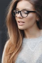 Portrait of beautiful woman in glasses on gray background Royalty Free Stock Photo