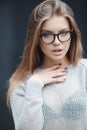 Portrait of beautiful woman in glasses on gray background Royalty Free Stock Photo