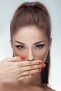 Portrait of beautiful woman with hand on lips over gray background Royalty Free Stock Photo