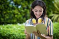 Portrait of a beautiful woman has reading a book with smiling and relax in the garden Royalty Free Stock Photo