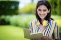 Portrait of a beautiful woman has reading a book with smiling and relax in the garden Royalty Free Stock Photo