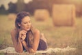 Portrait of a beautiful woman with hay bale Royalty Free Stock Photo