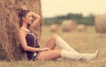 Portrait of a beautiful woman with hay bale Royalty Free Stock Photo