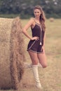 Portrait of a beautiful woman with hay bale Royalty Free Stock Photo