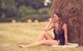 Portrait of a beautiful woman with hay bale Royalty Free Stock Photo