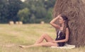 Portrait of a beautiful woman with hay bale Royalty Free Stock Photo