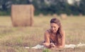 Portrait of a beautiful woman with hay bale Royalty Free Stock Photo