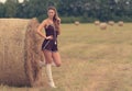 Portrait of a beautiful woman with hay bale Royalty Free Stock Photo