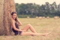 Portrait of a beautiful woman with hay bale Royalty Free Stock Photo