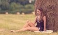 Portrait of a beautiful woman with hay bale Royalty Free Stock Photo