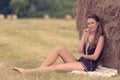 Portrait of a beautiful woman with hay bale Royalty Free Stock Photo