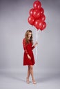 Portrait of beautiful woman holding a bunch of balloons Royalty Free Stock Photo