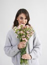 Beautiful woman holding bunch of flowers in studio shot Royalty Free Stock Photo